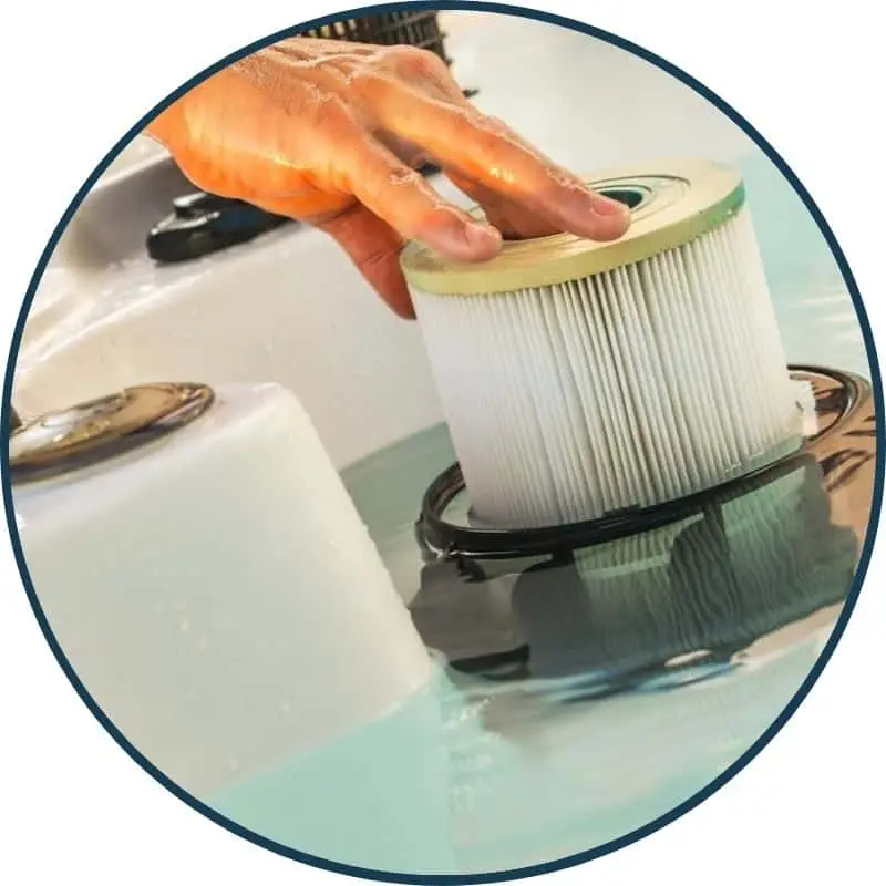 a hot tub filter being replaced
